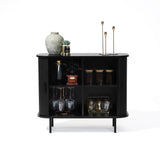 The LuxenHome Aria 2-door tambour accent cabinet in black finish features two shelves for glassware, jars, and decor. Its top holds a textured vase, small plant, and two tall candle holders for an elegant Mid-Century Modern vibe.