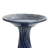 Blue ceramic birdbath with leaves and swirl pattern