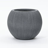 A round, ribbed gray planter pot crafted from durable polyethylene with a wide opening, set against a plain white background. This modern planter is UV-resistant, making it perfect for both indoor and outdoor spaces.