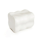 A white, abstract, wavy-shaped sculpture with a smooth surface, resembling a cloud or organic form, crafted from MgO material.