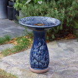 Blue ceramic birdbath with petals and vines pattern