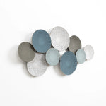 This abstract metal wall decoration features nine overlapping round metal plates with intricate patterns in shades of blue and gray, adding an artistic touch to any home decor.