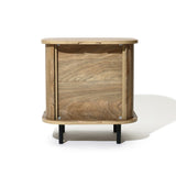 The Aria oak finish nightstand by LuxenHome is a mid-century modern piece with a rectangular shape, smooth edges, visible wood grain, and four black legs. Its minimalist design and slatted sliding door make it an ideal bedside table, beautifully showcased against a white background.