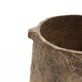 Close-up of a weathered, brown clay pot with a small spout on the rim, resembling a ginger root brown vase. The pots textured surface and earthy tones are visible against a plain background.