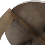 Close-up of a mid-century modern side tables underside, revealing a leg attachment with a bolt and washer. The wood has a natural brown finish that complements the sleek design, reminiscent of classic walnut veneer tables.