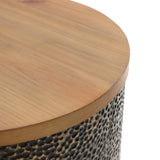 A close-up of a round wooden tabletop with a textured hammered iron base enriches the design.