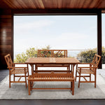 dining-table-and-chairs-on-a-rug-with-a-large-window-and-a-view-of-the-ocean