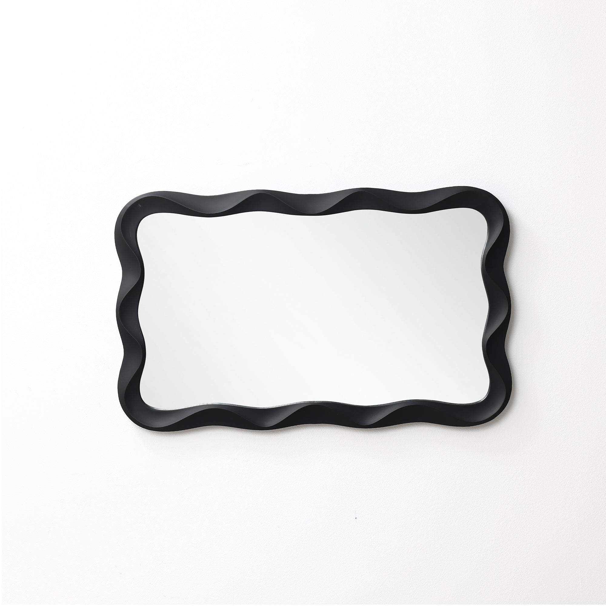 Modern wall mirror featuring a wavy black frame adds a stylish touch, beautifully mounted on a white wall.