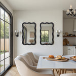 Two striking wavy frame mirrors on the wall. Enhancing the bright, contemporary space.