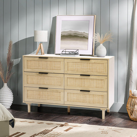 a 6-drawer dresser in a bright coastal style living room set up with vase, lamp and a wall art on top