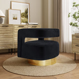 A modern black velvet accent chair with a 360-degree rotation and a gold base sits on a circular rug in a stylish room with wooden cabinets and framed pictures.