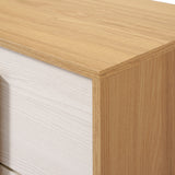 Close-up of a wooden dresser corner with a light brown top and white woodgrain front panels, showcasing its elegant wooden finish.