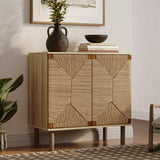 A wooden cabinet with handcrafted jute woven doors, topped with a vase, bowl, and stacked books, stands against a beige wall with a framed picture above. Embracing natural modernism, it features adjustable shelves for convenience, while a plant adds a touch of greenery beside it.