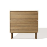 A wooden cabinet with two drawers and handcrafted jute woven doors epitomizes minimalist design against a plain white background, embracing a touch of natural modernism.