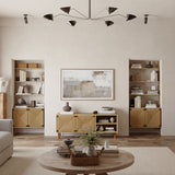 A minimalist living room in neutral tones, showcasing mid-century modern wooden shelves and cabinets. It features a round coffee table, a framed abstract painting, and a modern black chandelier, all seamlessly integrated with a woven rope facade for added texture.