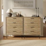 A modern living room features two LuxenHome Casper mid-century 4-drawer chests with metal legs. A lamp, vase, and candlesticks adorn the walnut-toned tops. A textured artwork hangs above, complemented by a cozy beige carpet in mid-century style.