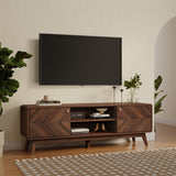 A modern living room features a wall-mounted flat-screen TV above the LuxenHome Theo mid-century modern walnut finish TV stand, which holds books and decor. Potted plants flank it for style. Clever cable management ensures tidiness, while a neutral-toned patterned rug graces the floor.