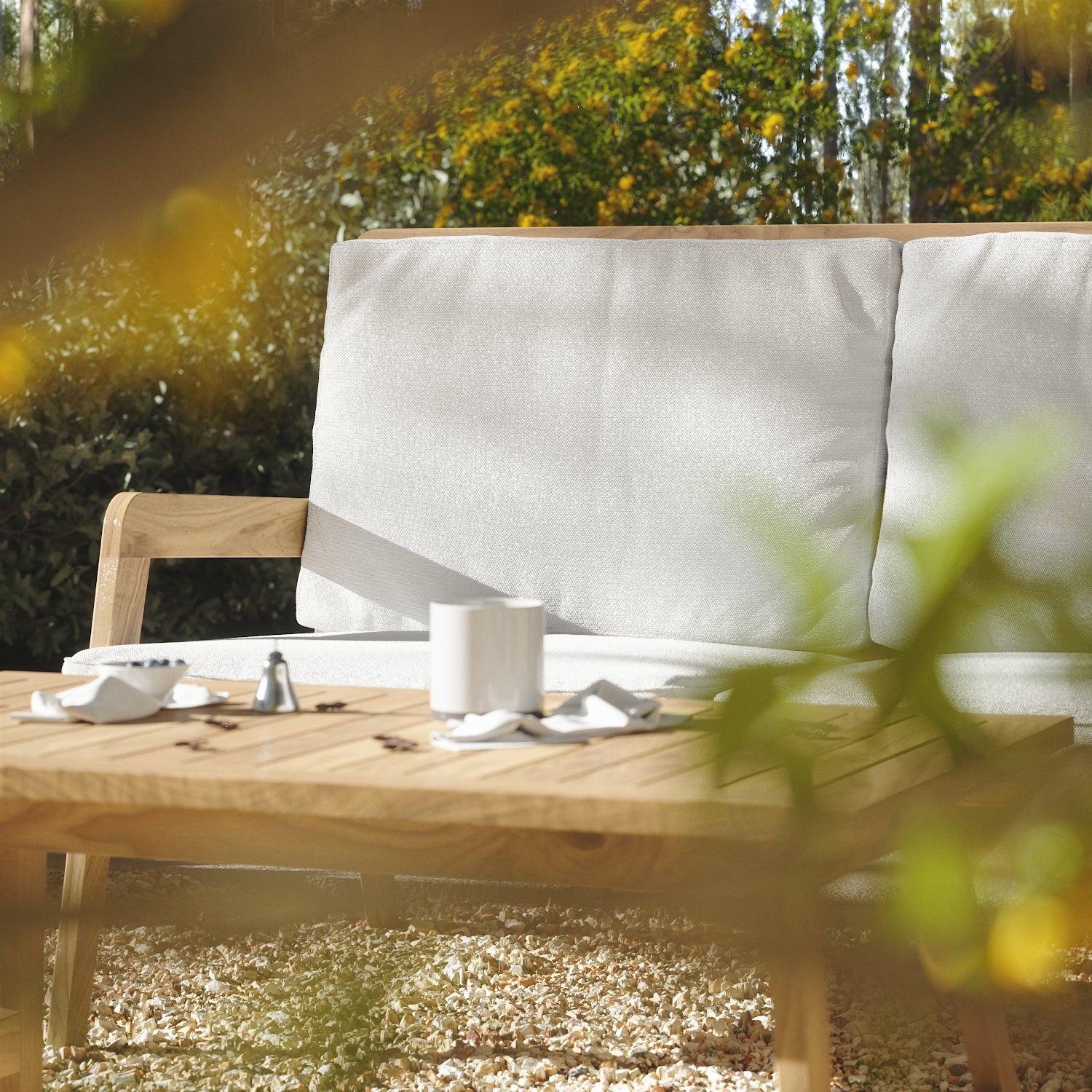 wooden-garden-bench-and-table-with-a-white-cloth-and-a-cup-of-coffee