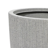 Close-up of a textured, gray cylindrical planter with a modern striped pattern and ribbed surface, showing the upper rim—a perfect addition to any home and garden.