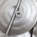 A close-up of round metal objects painted silver, curated as an abstract design with a central rod and circular attachment, perfect for modern metal wall art.