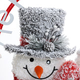 family-of-three-snowmen-is-adorned-with-red-striped-scarves-and-charming-hats