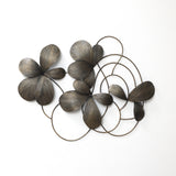 Bronze-colored metal wall sculpture featuring abstract flower petals and circular loops arranged.