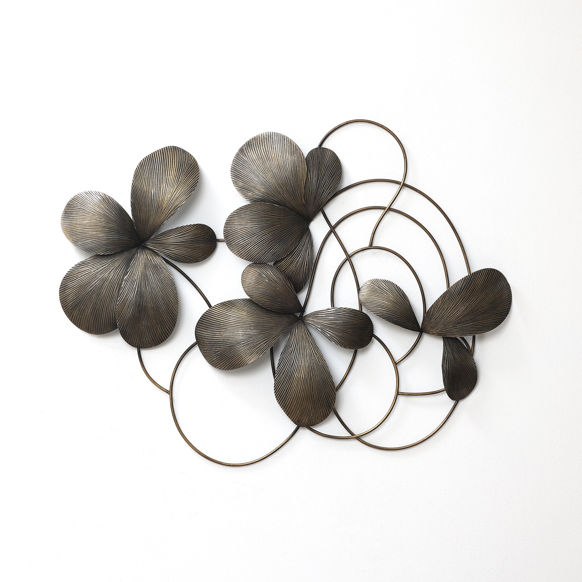 Bronze-colored metal wall sculpture featuring abstract flower petals and circular loops arranged.