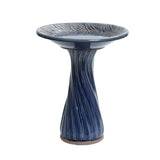 Blue ceramic birdbath with leaves and swirl pattern