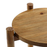 Close-up of a wooden round table with three cylindrical legs, showcasing its rich chestnut finish and natural wood grain texture.