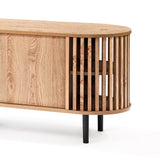 Mid-century modern TV cabinet with an oval shape, featuring slatted sides and a smooth surface. The light wood grain finish beautifully contrasts the black metal legs, while its sleek sliding door design adds both style and functionality.