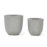 Two gray, textured cylindrical planters with a subtle modern striped pattern sit side by side on a white background, perfect for enhancing your home and garden.