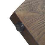 Close-up of a wooden surface, perhaps from a walnut veneer table, featuring a rounded black plastic stopper on its edge—likely part of an elegant mid-century modern side table.