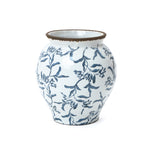 Handcrafted floral ceramic vase featuring a rounded white body, brown rim, and blue floral patterns.