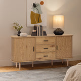 Buffet cabinet sideboard, a mid century wood storage unit with three drawers and two cabinets, topped with books, a lamp, a plant, and décor, standing against a wall with abstract art.