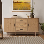 Buffet cabinet sideboard, a mid century wood storage cabinet with three drawers and two cabinets, topped with books, vases, and decor, standing against a wall with a framed landscape painting.