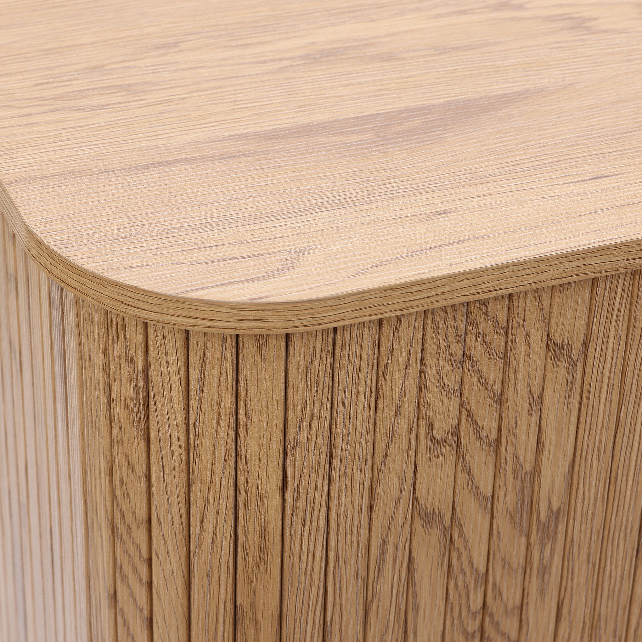Buffet cabinet sideboard, close-up of the corner of a mid century storage cabinet with a light oak finish and vertical grain pattern, highlighting detailed craftsmanship.