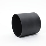 A durable black cylindrical pot is artfully placed on its side against a white background, showcasing its versatility as both indoor and outdoor decor. Ideal for those seeking stylish planters to elevate their garden or patio aesthetics.