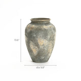 The LuxenHome Rustic gold and brown terracotta urn vase, standing 13.6 inches tall with a textured gray and beige surface, features an antique distressing technique and is elegantly displayed against a plain white background.