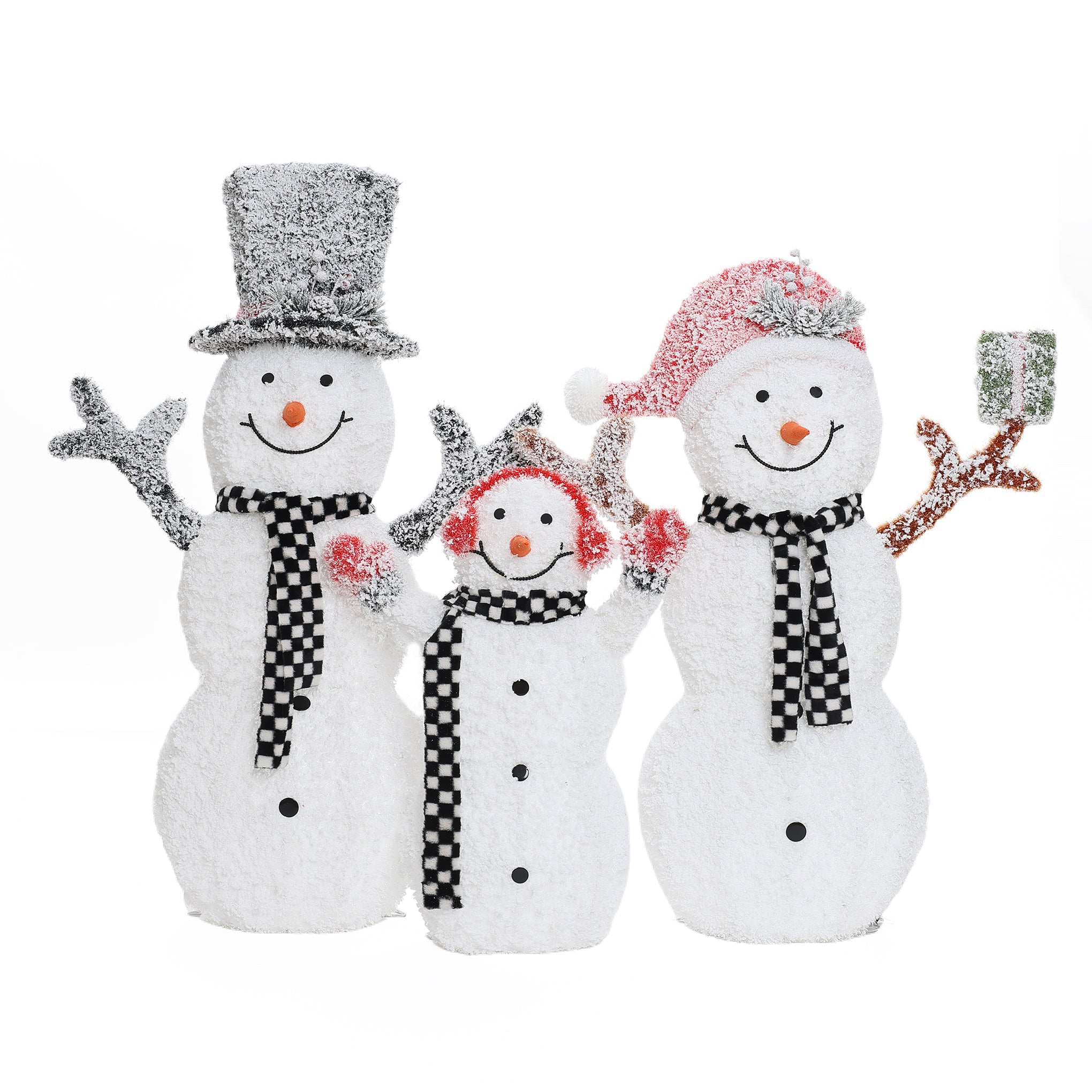 Three snowmen with black and white scarves, smiling faces, and red accessories stand together as a charming outdoor Christmas decor; one holds a small wrapped gift.