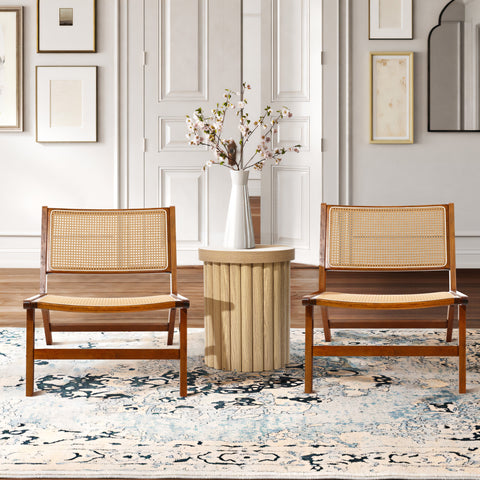 set of 2 accent chairs made with solid wood frame and rattan backrest in a living room set up. And wood fluted end table in the middle of the chairs with a white ceramic vase on top of the end table.