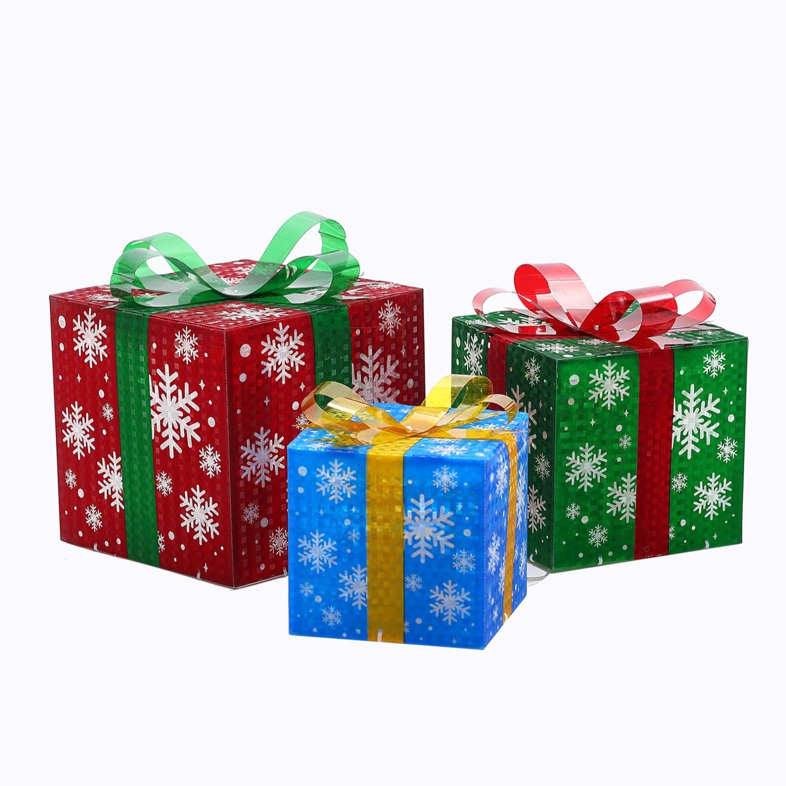 Wrapped gift boxes with snowflake patterns, one red with a green ribbon, one green with a red ribbon, one blue with a yellow ribbon.