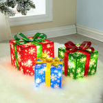 Three illuminated LED gift boxes with snowflake patterns and bows, in red, green, and blue for festive holiday decor.