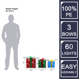 Three decorative LED gift boxes of varying sizes with bows and snowflake patterns are shown beside a silhouette for scale.