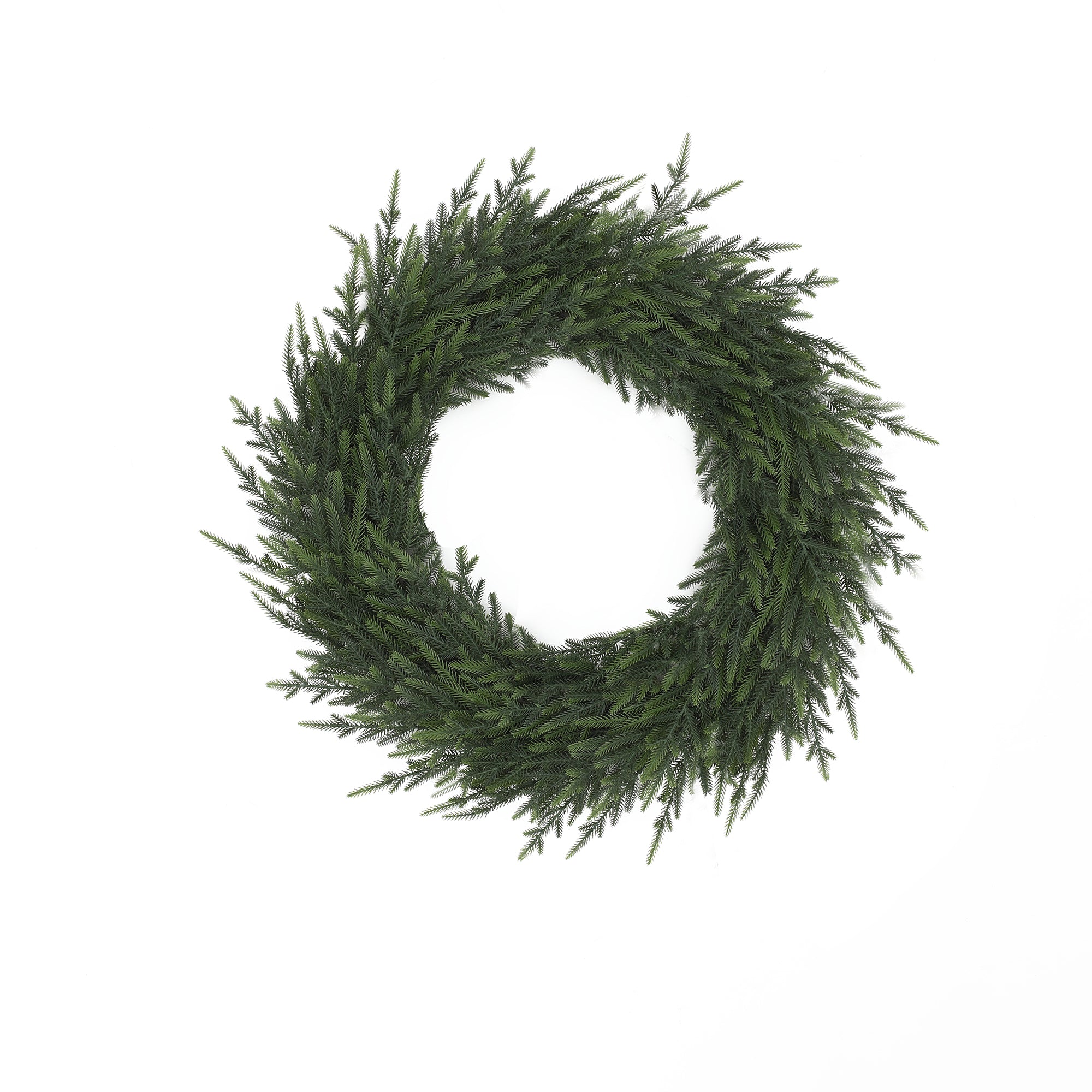 Artificial wreath made of pine branches forms circular holiday decor, against a plain white background.