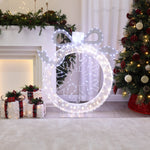 Pre-lit led wreath with a bow stands next decor christmas tree,wrapped presents in festively adorned living room.