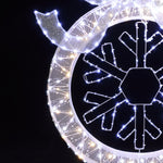 Close-up of illuminated snowflake decor with white led lights ,festive led wreath striking.