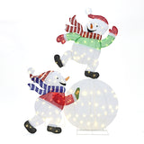 2 cheerful snowmen with scarves, hats shine brightly, one stands atop a glowing ball ,the other support from below.