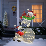 2 illuminated snowman holiday decor ,one climbing ball, the other stand in front of house adorned with lights, wreath, snow.