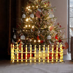 Close-up of white plastic fence segment with decor swirl design,flat base, displayed on a gray surface.