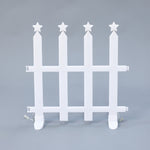 White plastic picket fence with 4 vertical posts, each topped with 5 pointed star, against plain gray background.